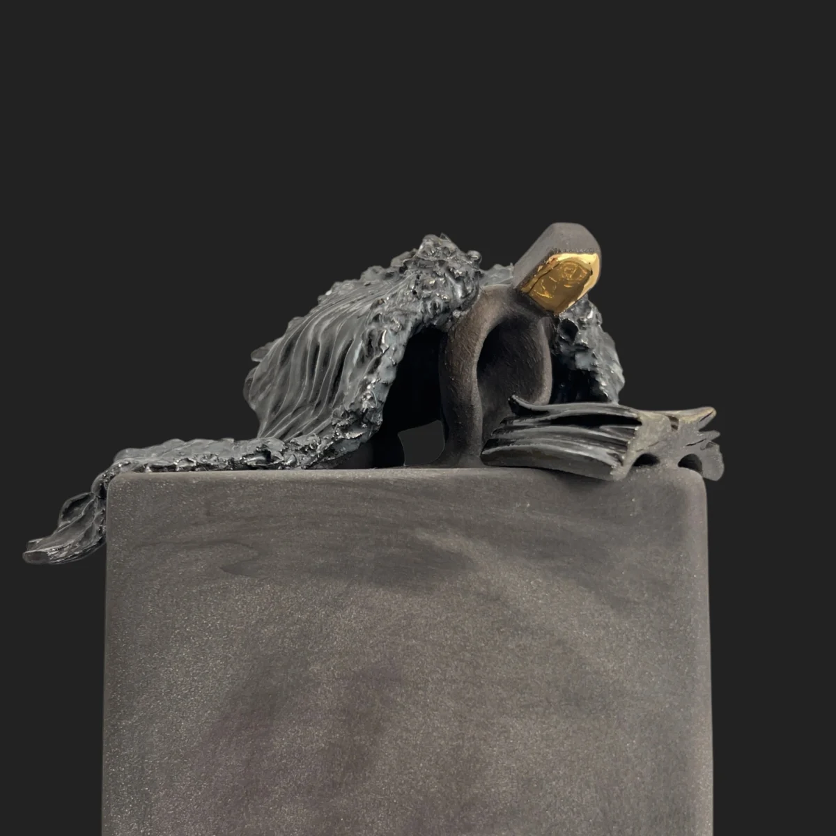 Sculpture "Angel": an angel kneeling beside the family book