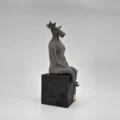 Sculpture "Dignity", seated figure with moose antlers, side view